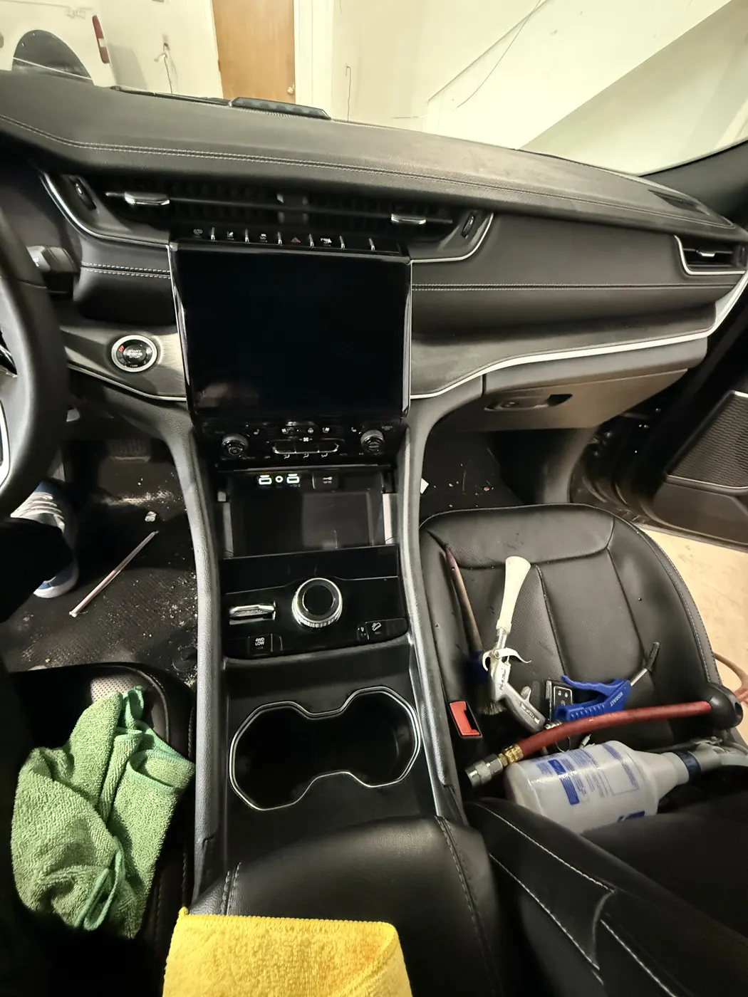 The same console wiped down, cupholders and tray empty and clean