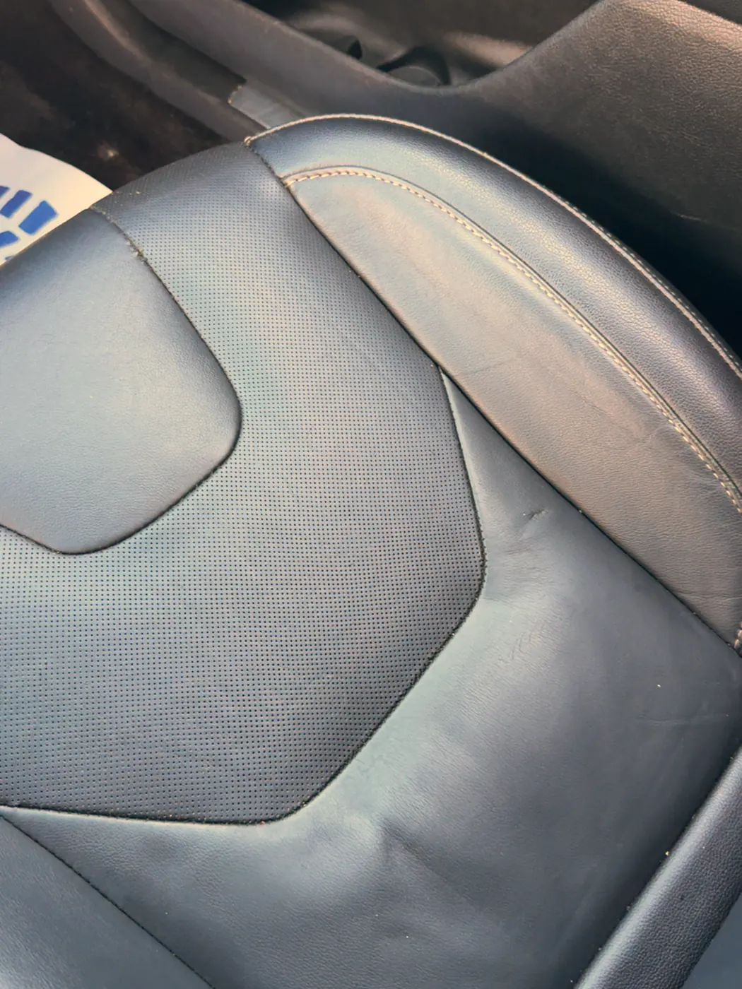 The same seat cleaned and conditioned, perforations clear