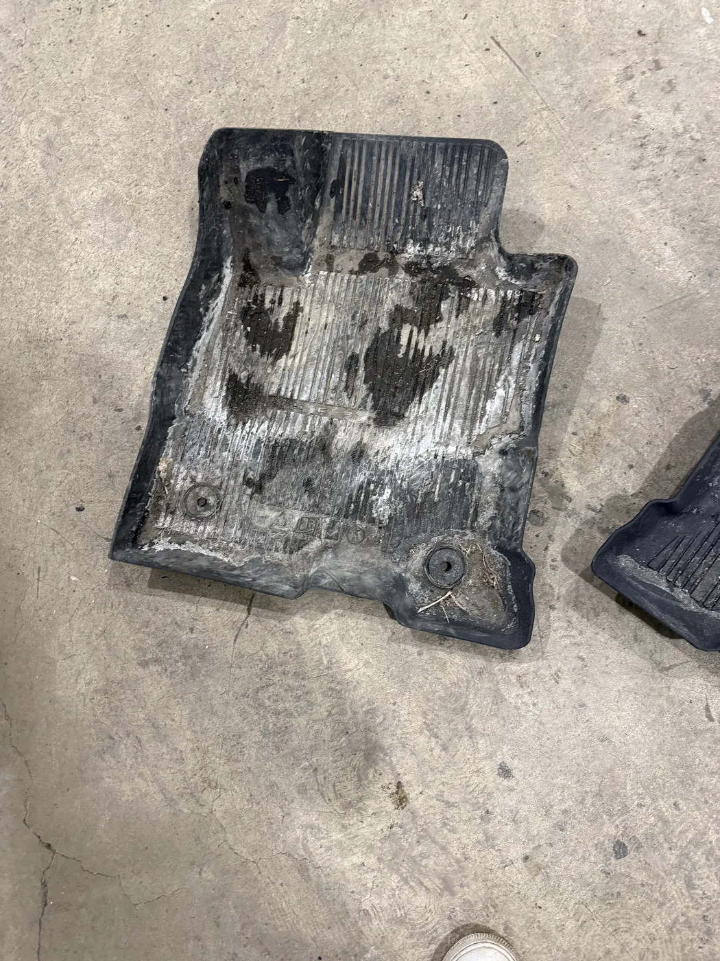 All-weather floor mat caked with dried salt and mud