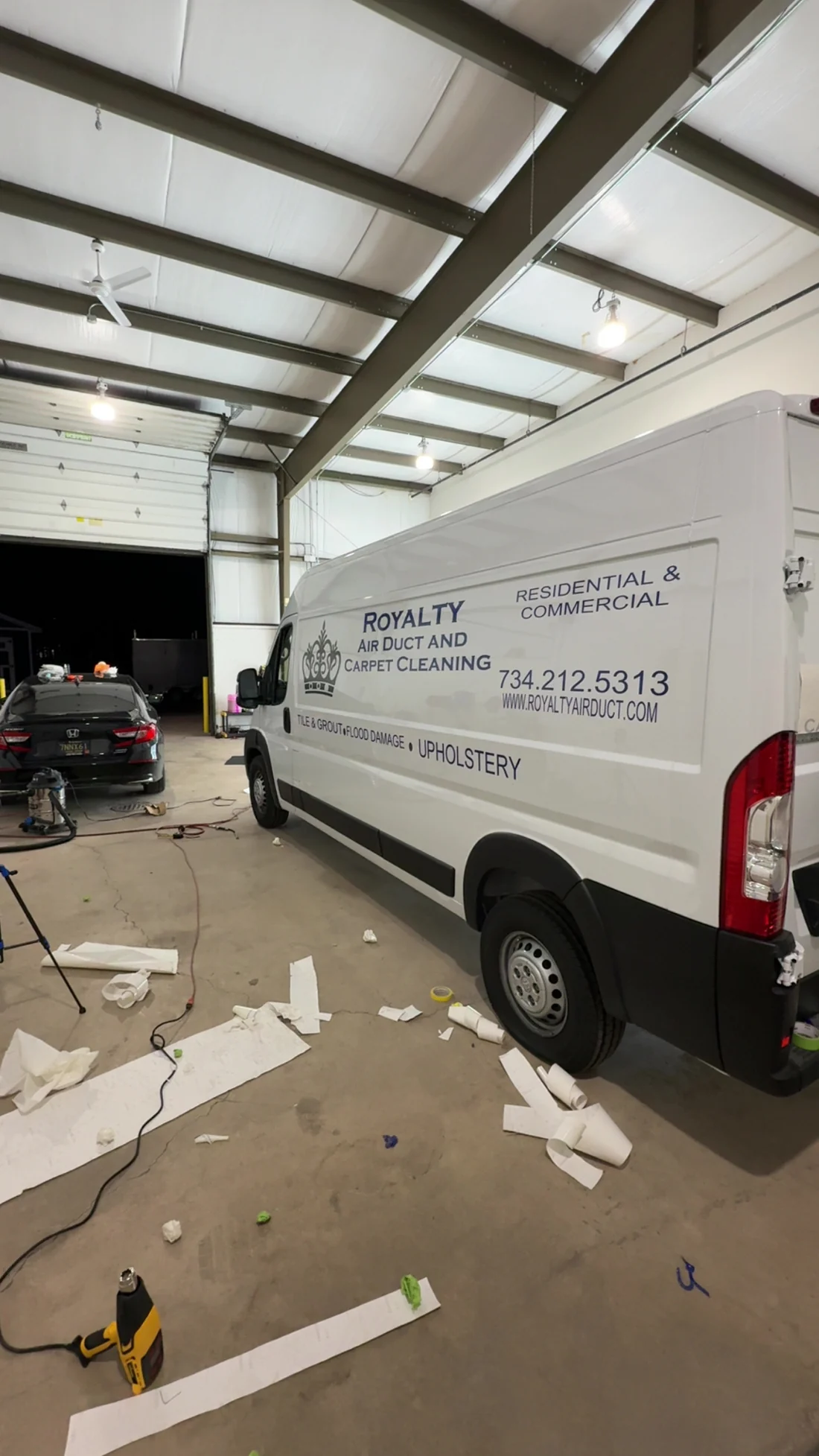 White van with Royalty Air Duct and Carpet Cleaning lettering, backing paper and offcuts still on the shop floor
